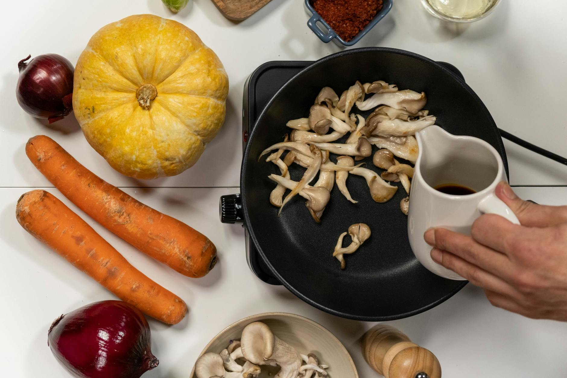 Oyster, Shiitake, and More: Best Mushrooms for Effortless Home Growing Top view of cooking mushrooms with autumn vegetables for a flavorful dish.
