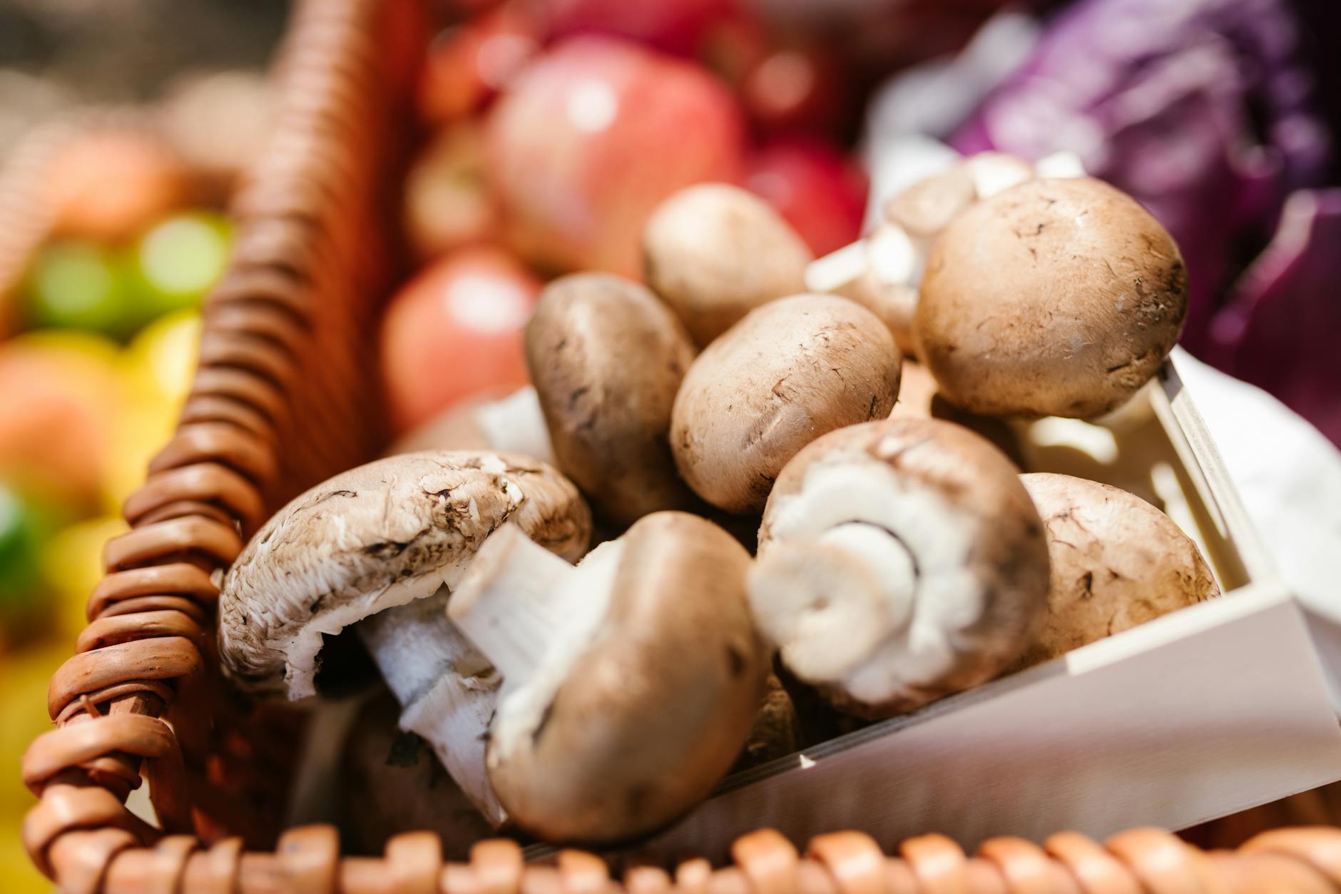 Close-up of fresh organic mushrooms in a wicker basket, perfect for healthy cooking.