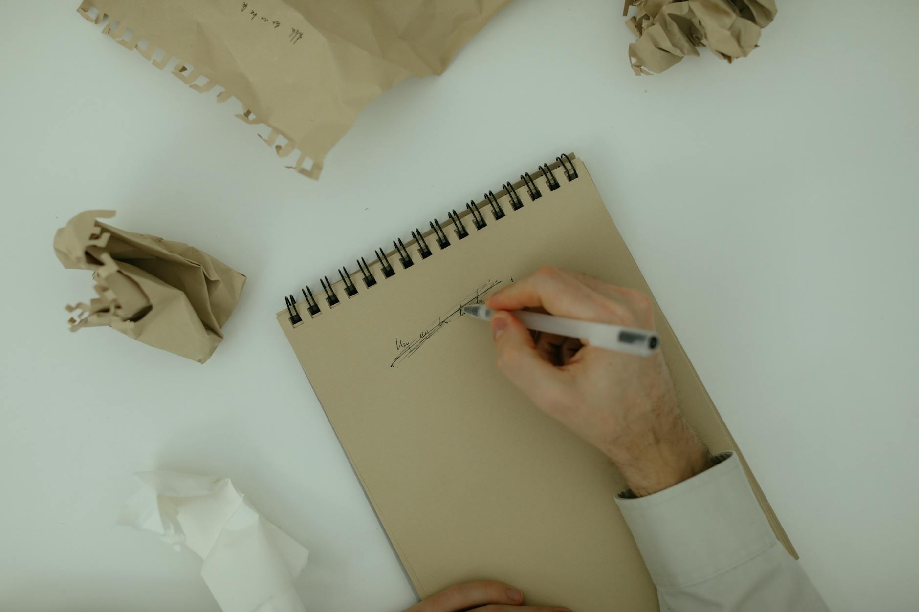 Eco-Friendly Mushroom Growing: Best Sawdust Recycling Substrates Person writing on a notepad surrounded by crumpled paper, symbolizing brainstorming and creativity.